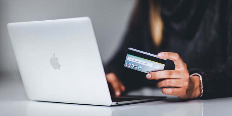 Person entering credit card information on live stream donation platform on computer