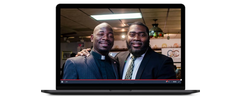 Minister and a church staffer speak to webcam live stream on a laptop