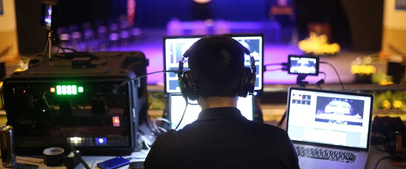 Media director produces a live stream at a production table