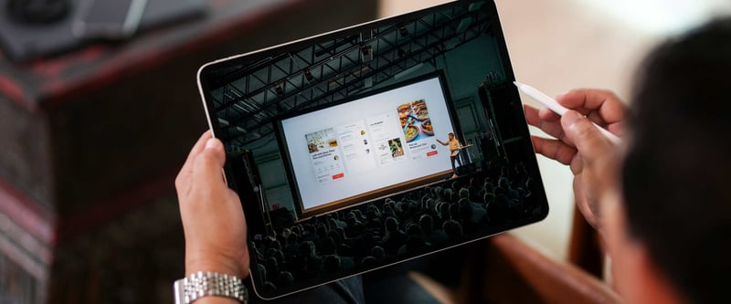 Person watching live stream keynote on a tablet