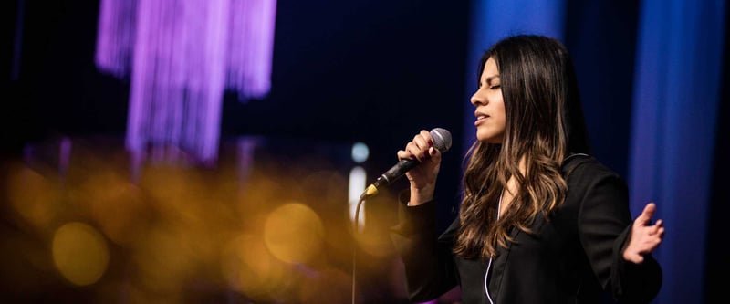 Pastor speaking in to church microphone on stage