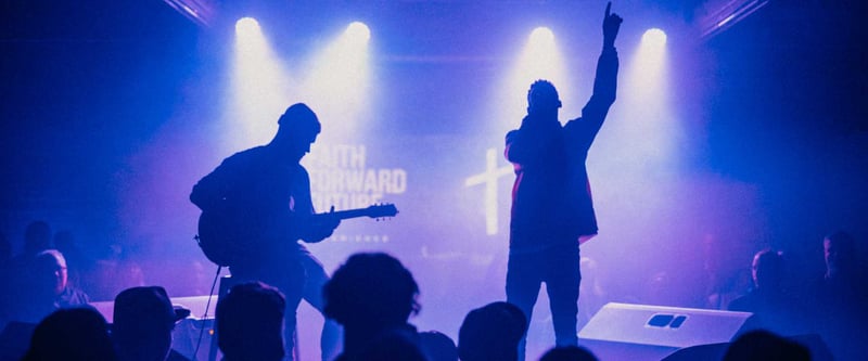 Musicians performing on church stage with lights streaming down from above