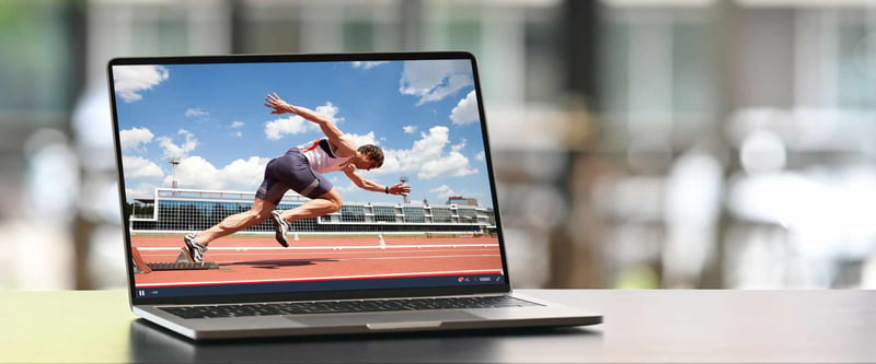 Laptop with blazing fast speeds showing video of an Olympic sprinter