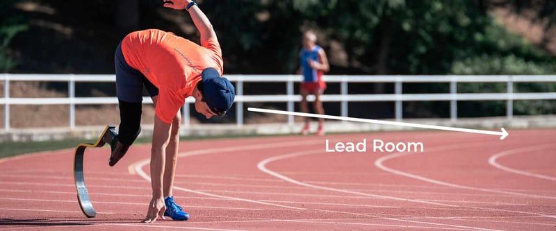 Image of an athlete running on a track with several feet of open space in front of them demonstrating lead room