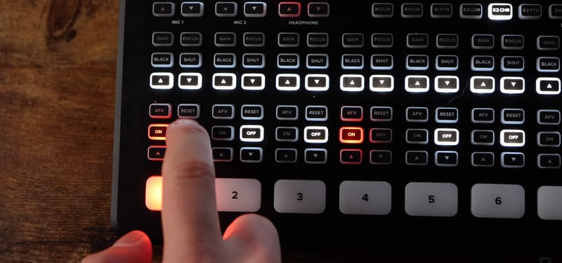 Hand tapping audio controls on Atem Mini Extreme ISO