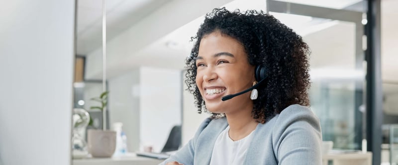 Happy, smiling customer support representative helping a church troubleshoot an issue