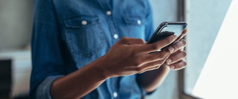 close up image of hands holding a mobile phone