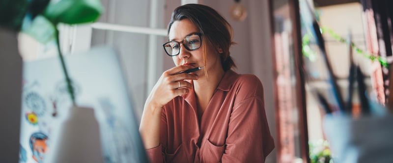 female web designer or artist pondering at screen