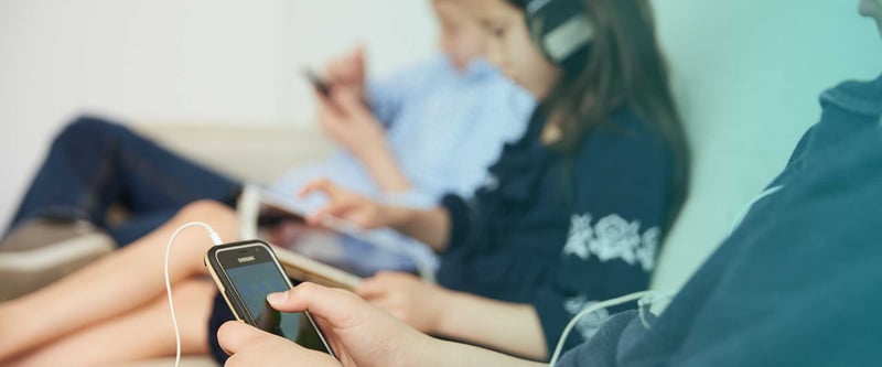 wide angle view of several youths using mobile devices