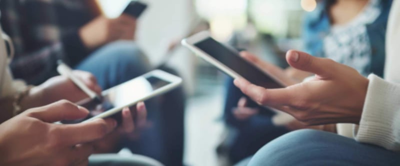 group of people using their mobile phones