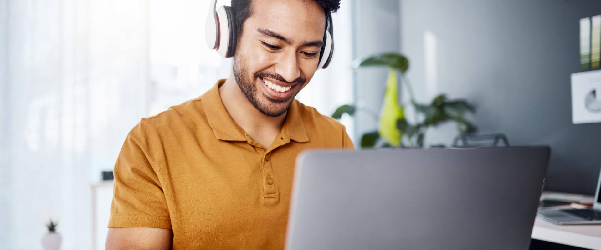 Person mixing audio remotely on laptop