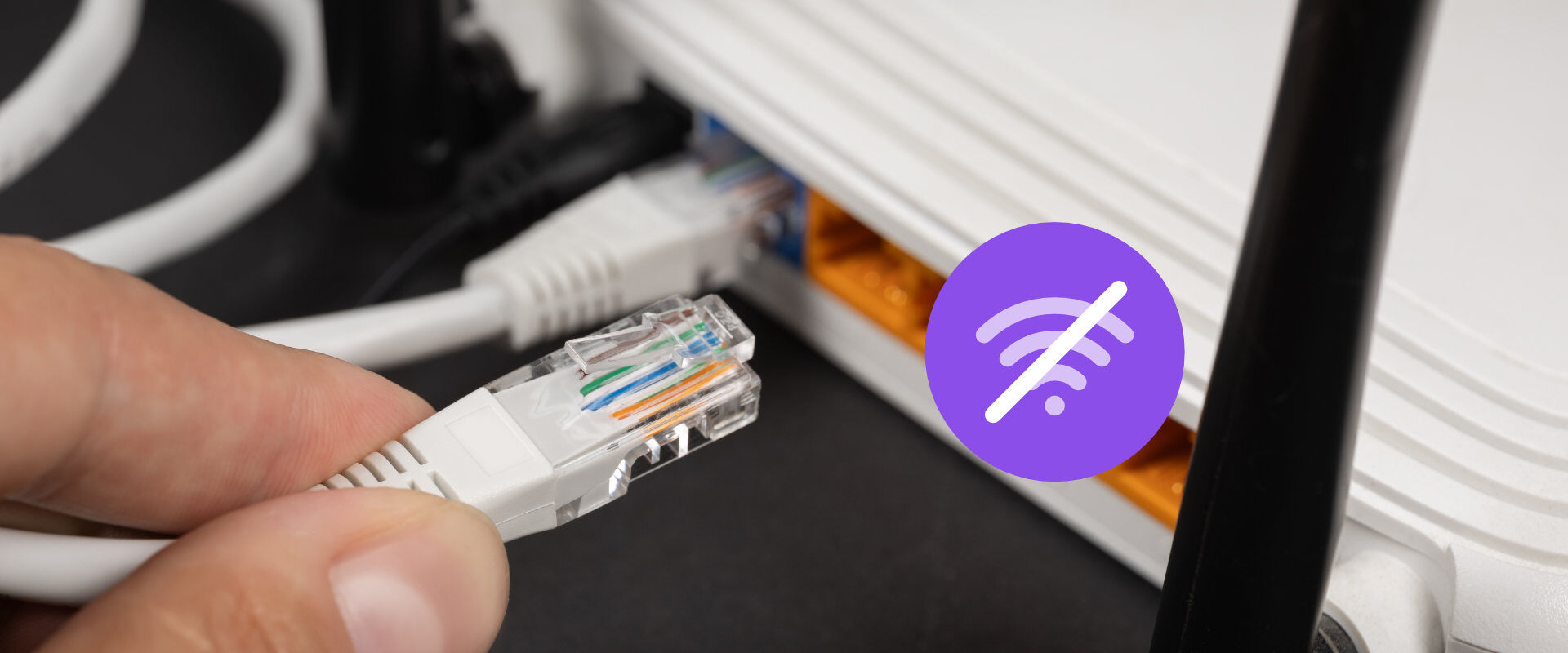 Person unplugging ethernet from wireless router