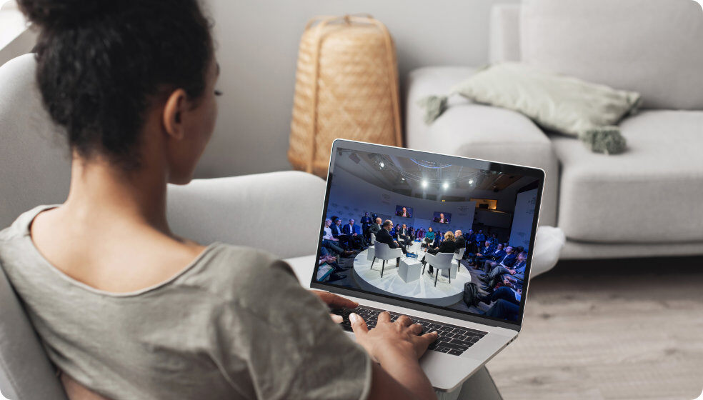 Woman watching 4K video of an event on a laptop