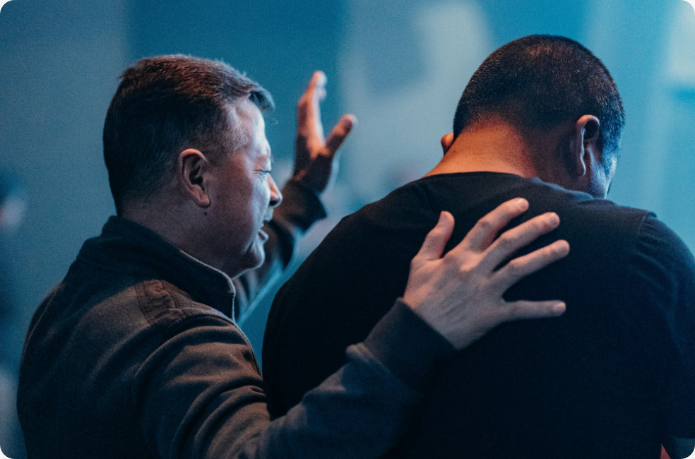 Pastor worshiping with a member of the congregation