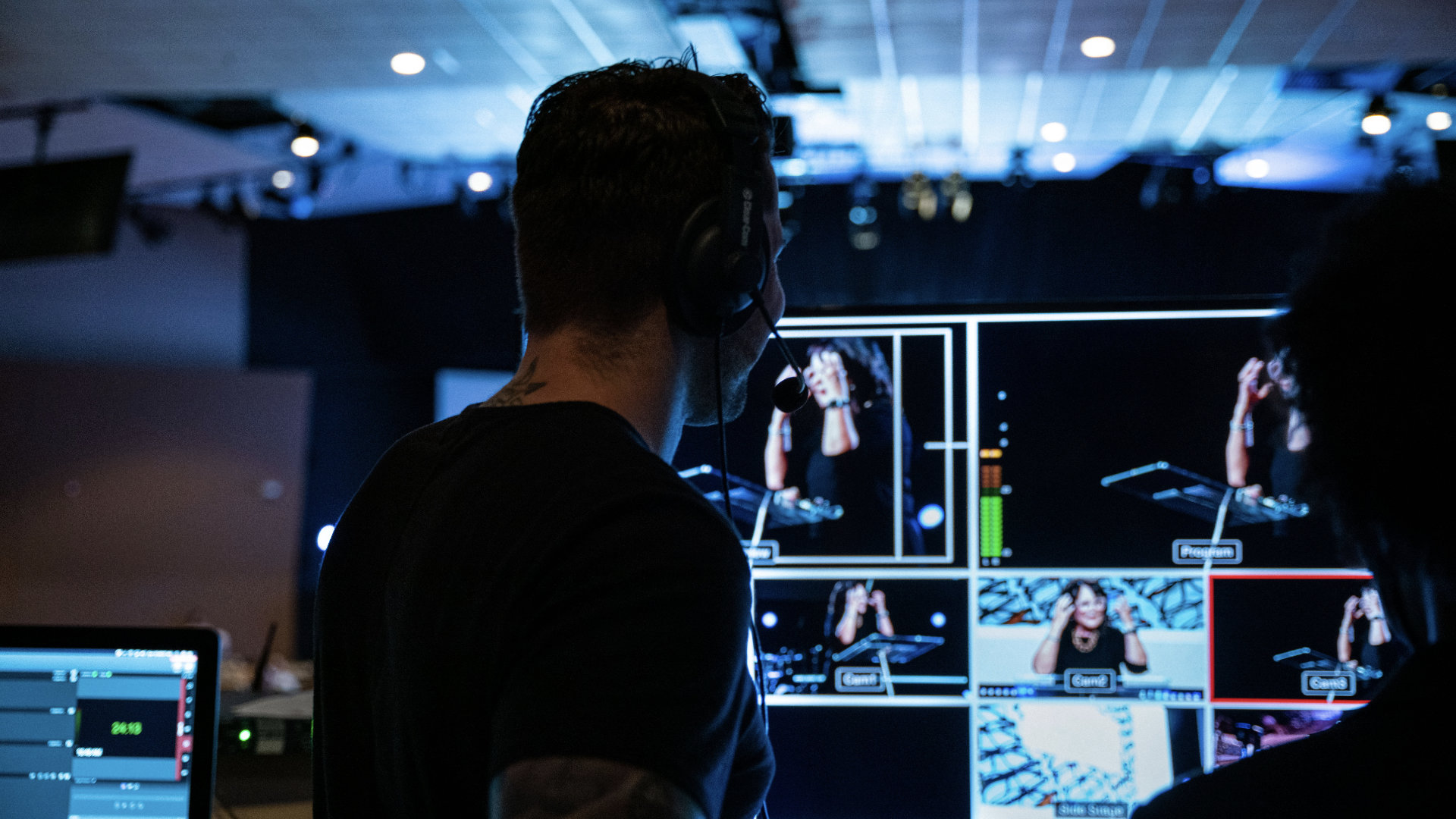 A church volunteer switching video during worship