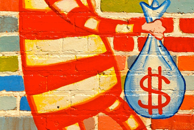 Image: Colorful wall mural of a person holding a bag of money