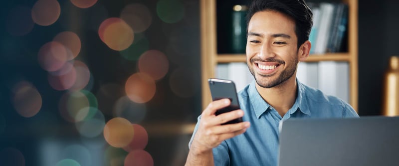 happy male using a website on a mobile phone