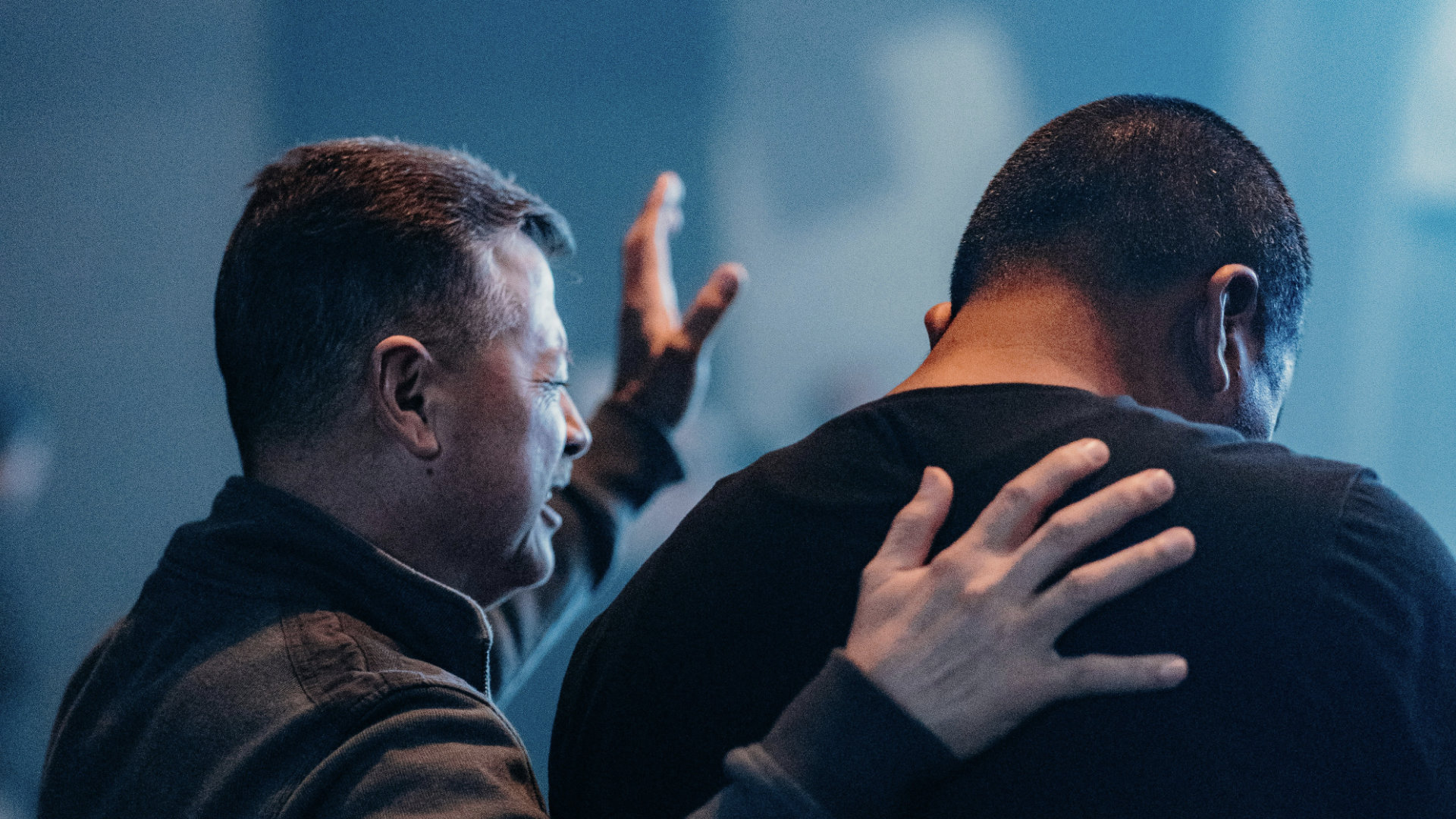 Pastor worshiping with congregation member