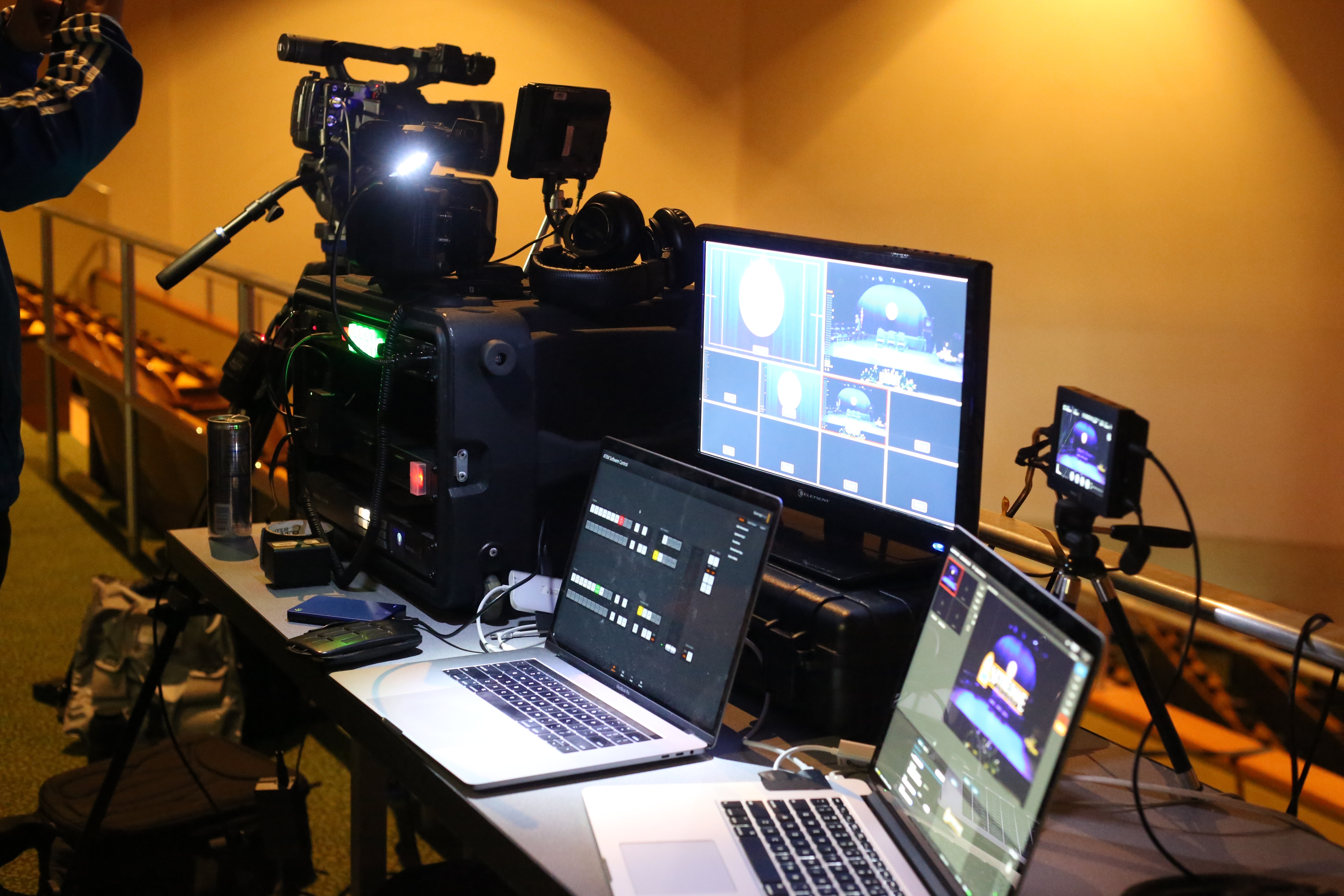 Live streaming setup with monitors, cameras, encoders, and computers