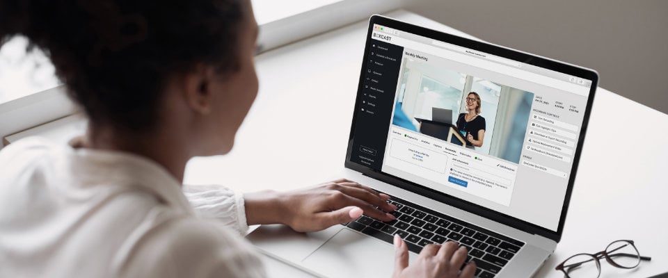 Woman at computer using the BoxCast Dashboard