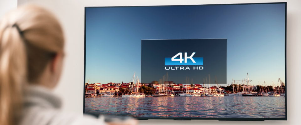 Woman watching 4K Ultra HD TV Live Streaming