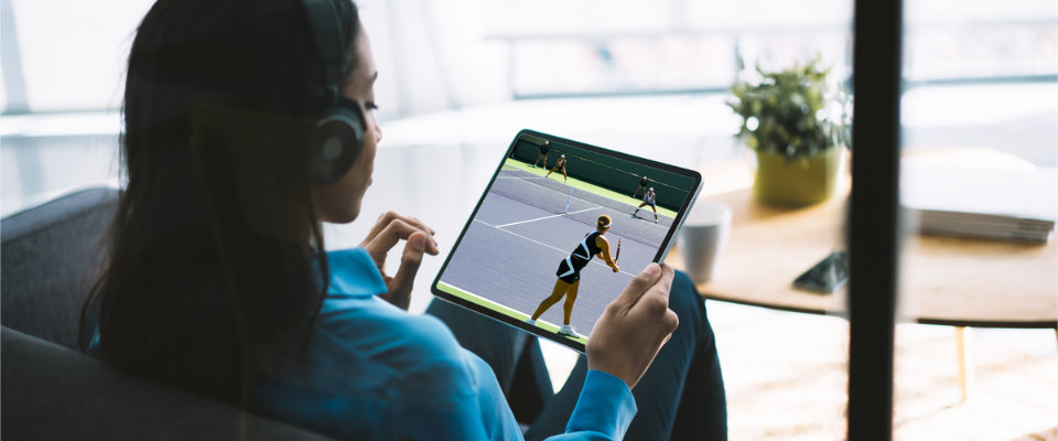 Woman watching live stream of tennis match on tablet