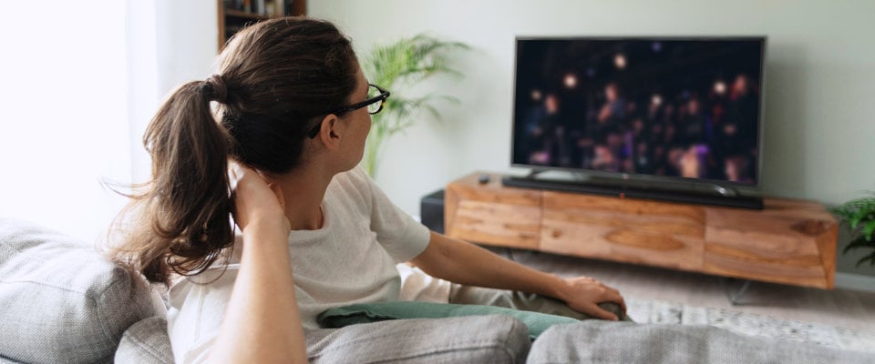 Woman watching video on demand on TV