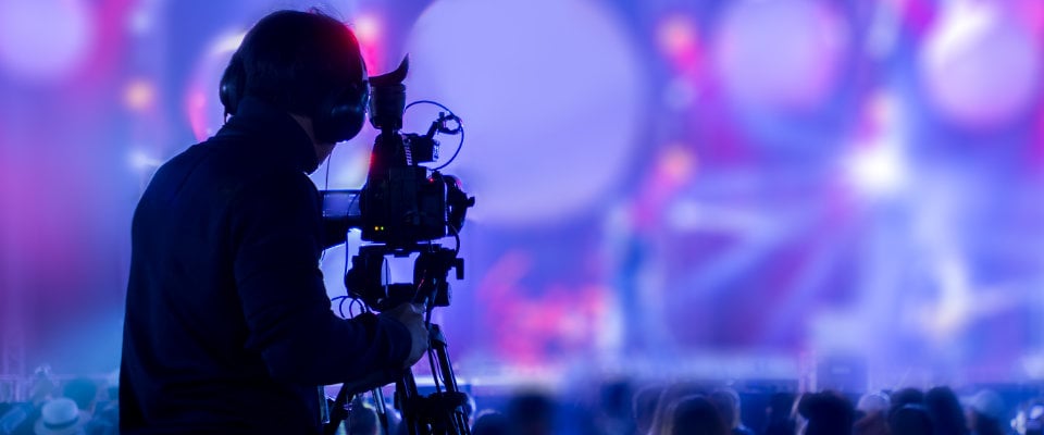 Videographer operating camera at a church service