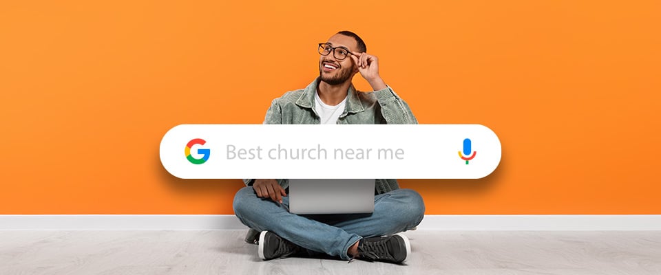 A man sitting down with laptop searching for best church near me
