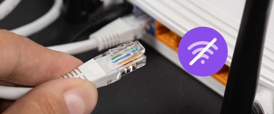Person unplugging ethernet from wireless router