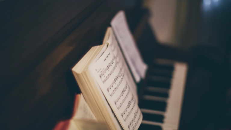 Hymnal set on top of a piano