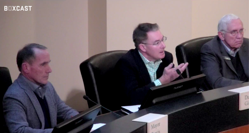 Three men in chairs discuss city council