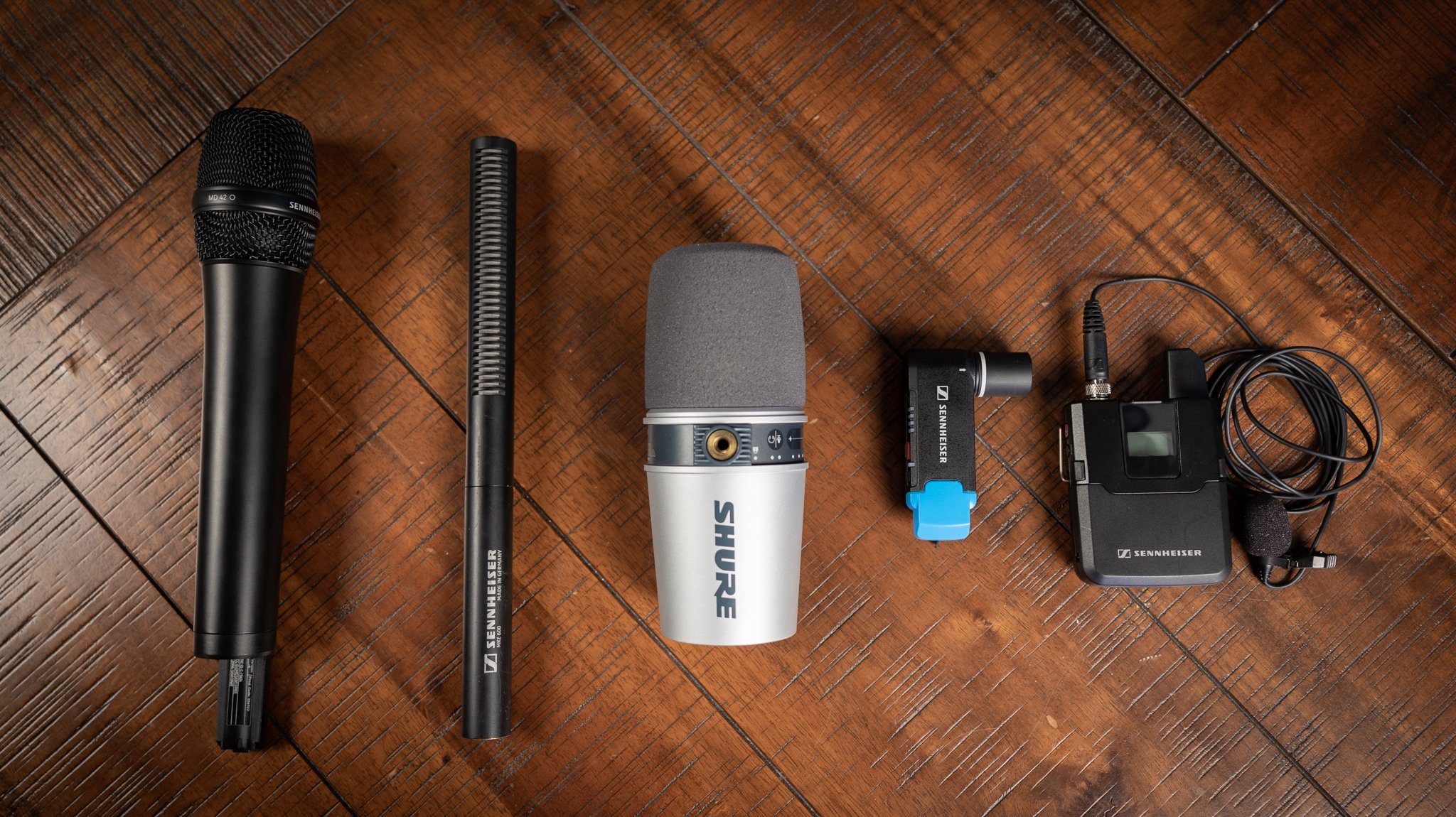 5 different microphones displayed on a table